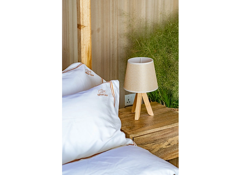 bed-side-table-with-table-lamp-on-deluxe-double-room